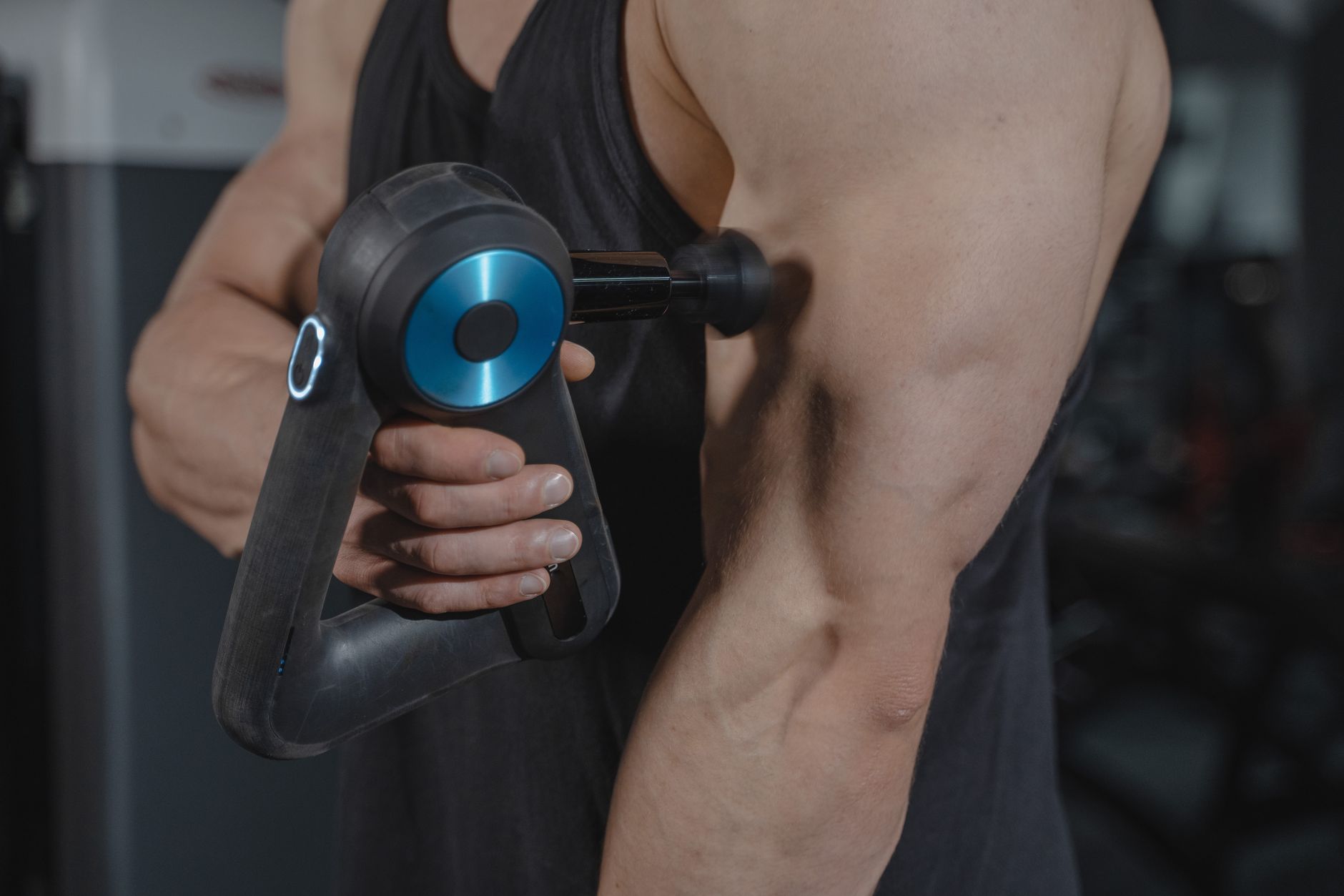 A powerful massage gun on a dark background, ready for muscle recovery