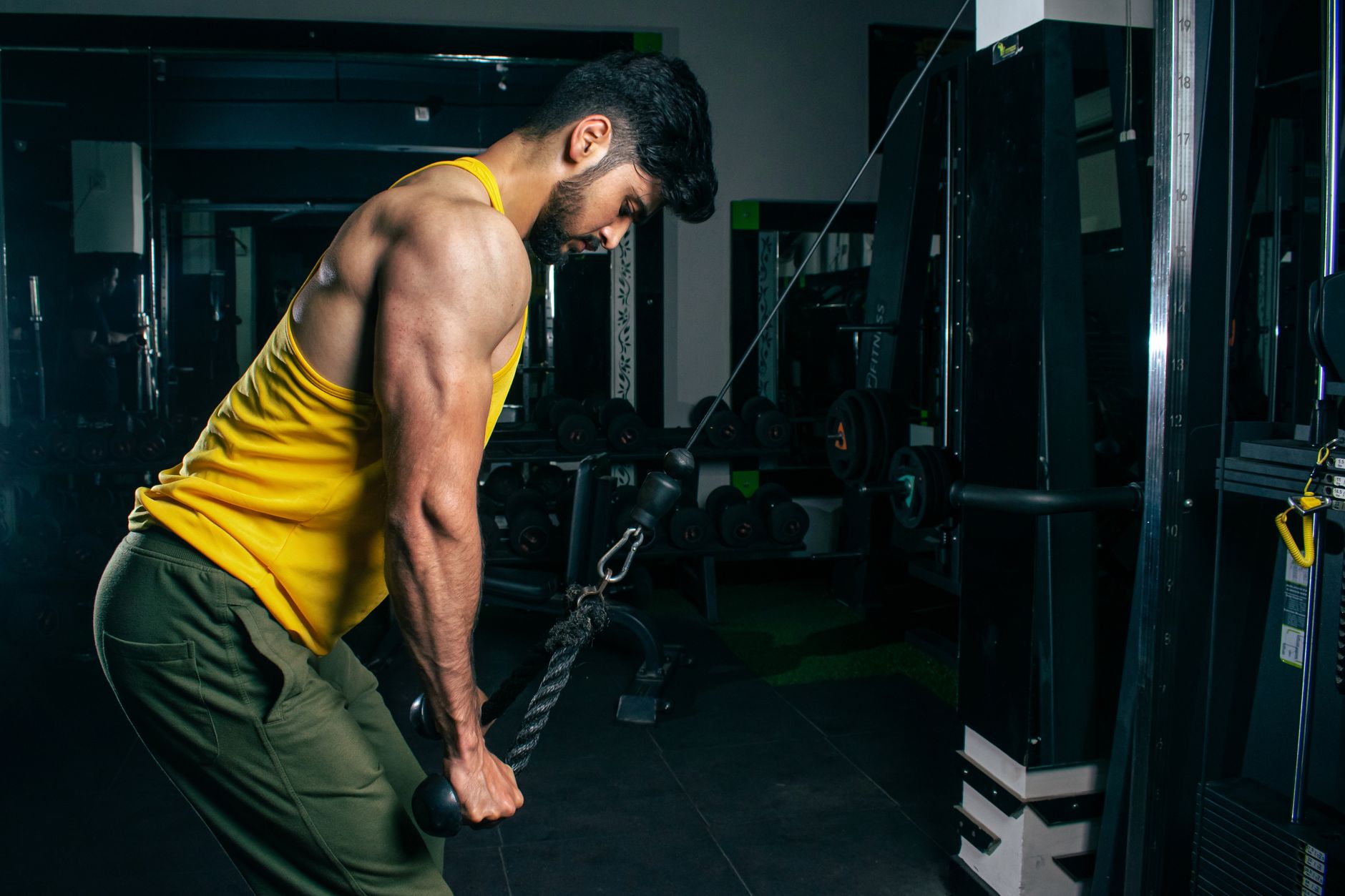 Man performing a heavy dumbbell bench press with focus
