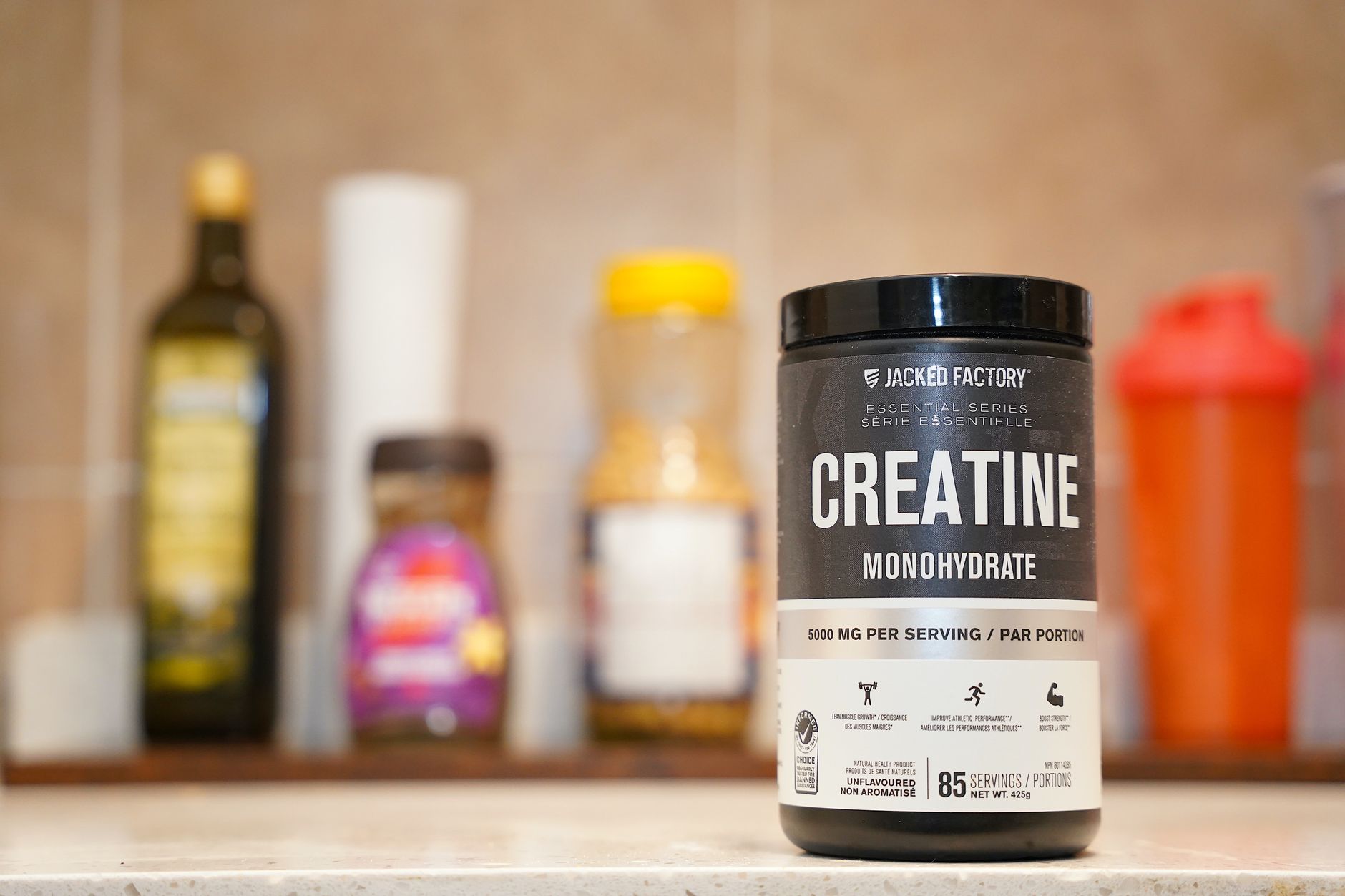 A scoop of creatine powder on a gym bench with weights