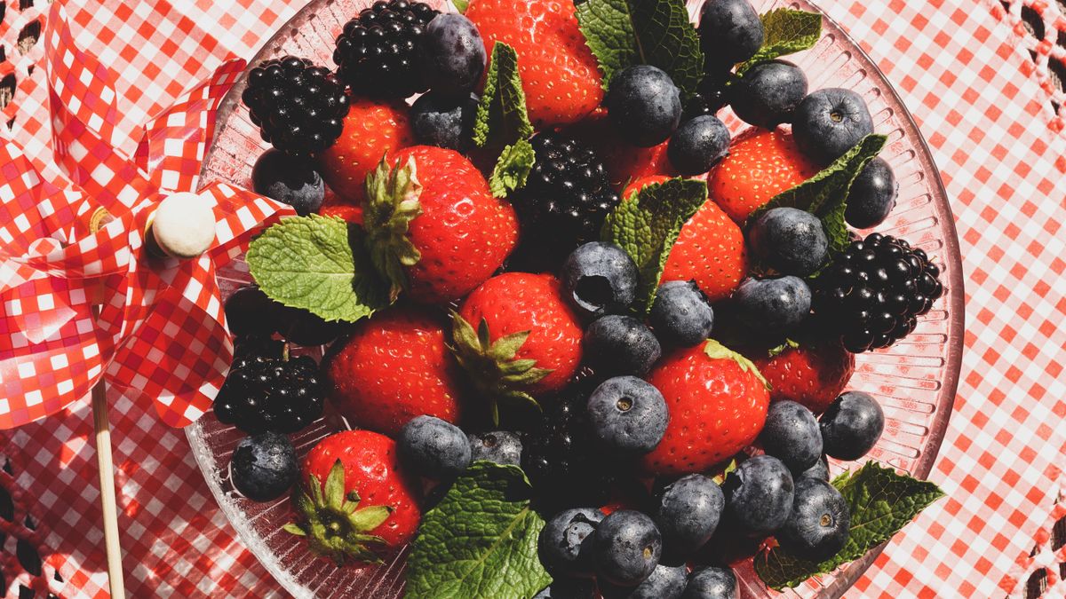 A vibrant assortment of fresh fruits including berries, apples, and oranges.