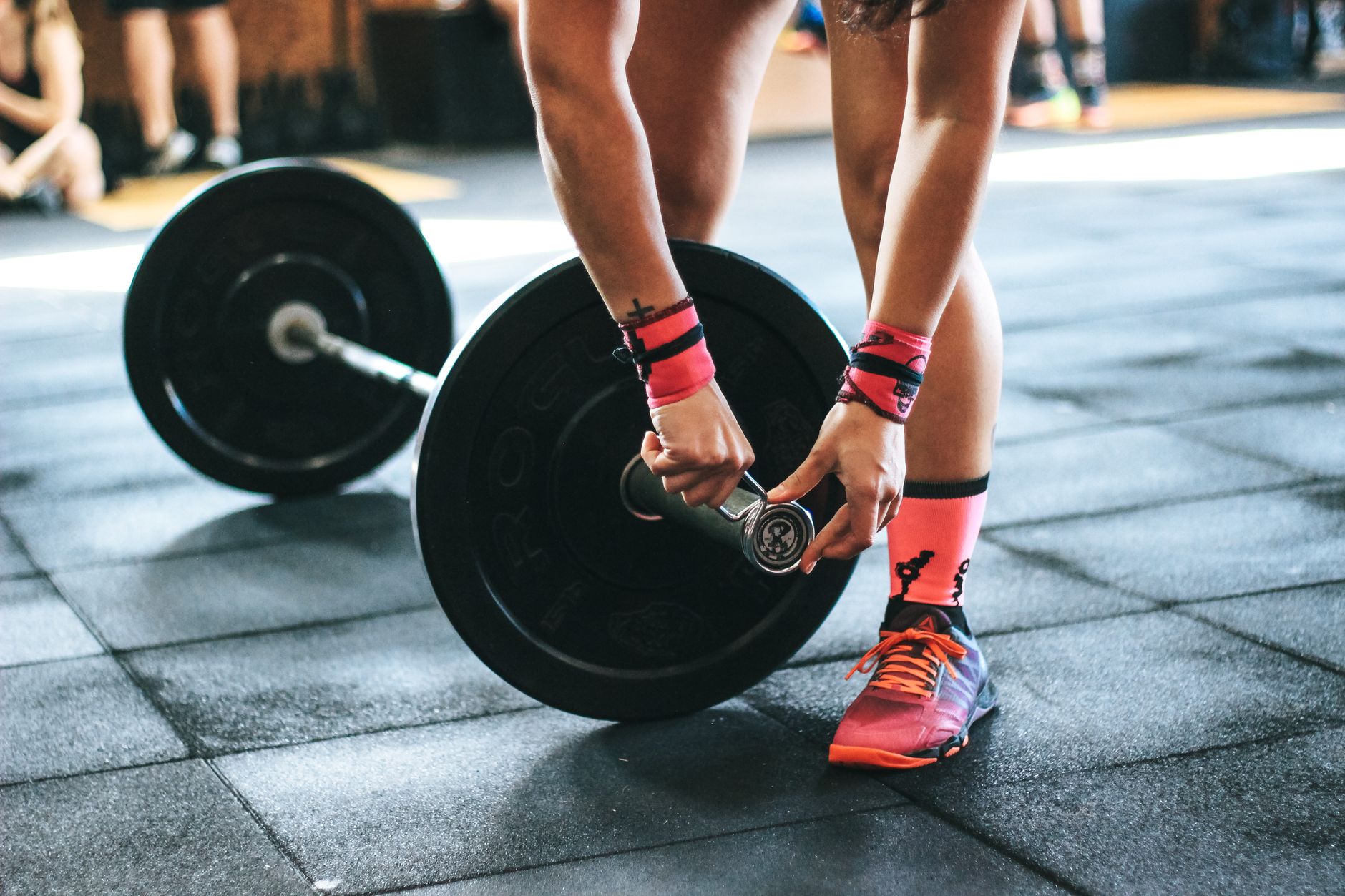 A lifter performing a heavy squat in a gym, demonstrating good form without visible struggle.