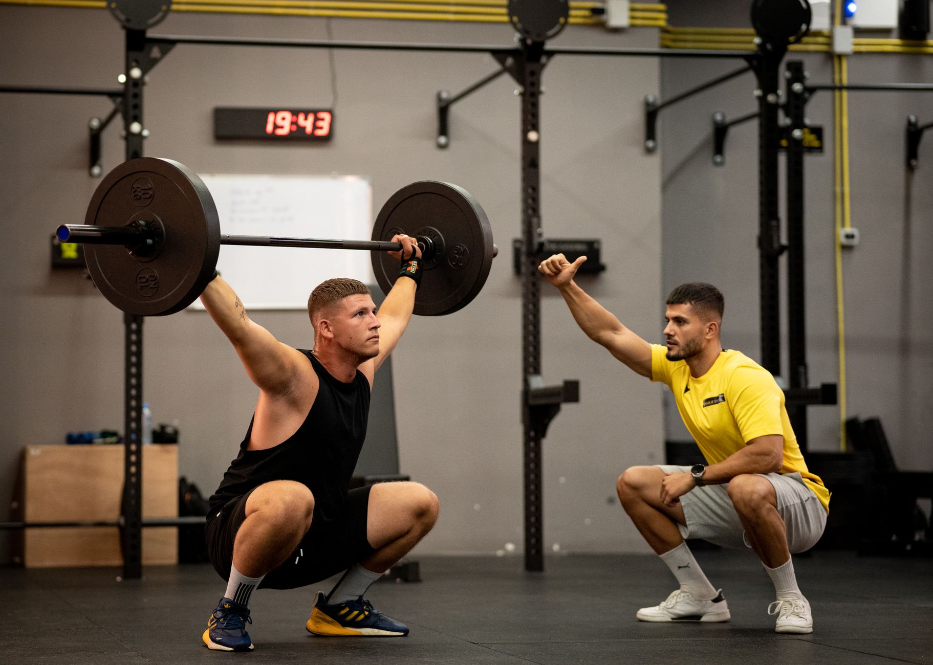 A lifter performing a barbell back squat with proper form.